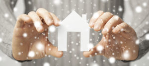 Mark Roemer image of two hands holding a house with snowflakes.
