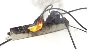 Mark Roemer image of a power strip on fire.