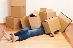 Mark Roemer image of a person with a pile of moving boxes on them