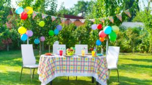 Mark Roemer image of a backyard birthday party with balloons, streamers, and a beautiful party table