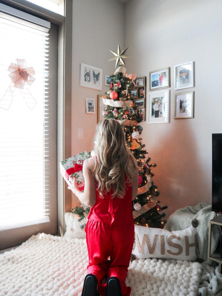 Mark Roemer image of a person on their knees decorating the tree
