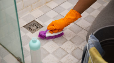 Mark Roemer image of a person cleaning the grout in their shower
