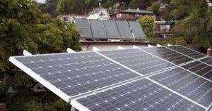 Mark Roemer Oakland image of solar panels on the top of a house.