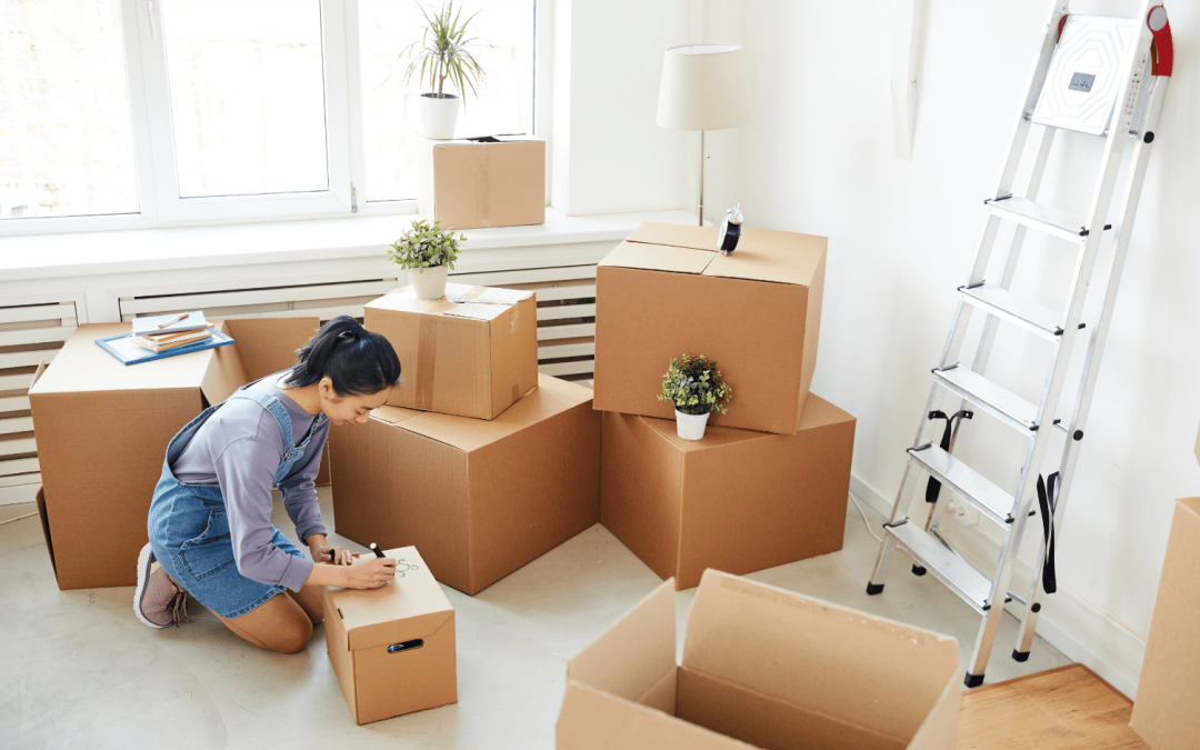 Mark Roemer image of a person sitting in the middle of a big room of boxes